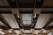 Ceiling with veneered timber panels and exposed services